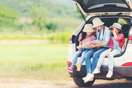 Group family children travel on car for adventure nature in vacations.  Asia people tourism checking map for explore natural destination and leisure trips travel for education.  Travel Conceptの写真素材