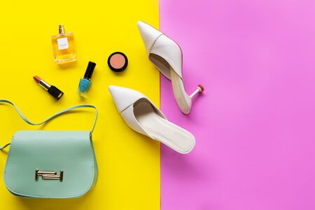 Fashion bag and shoe woman accessories pastel background. Trendy fashion luxury handbag, shoe, perfume and cosmetic design. Lifestyle and Beauty Conceptの写真素材