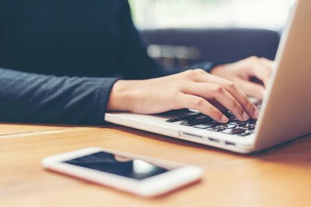 Young people work from home with laptop and drinking coffee in morning relax at home. Asia woman...