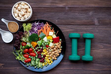 Diet Healthy food and lifestyle health concept. Sport exercise equipment workoutÂ andÂ gym background with nutrition detox salad for fitness style. Healthy Conceptの写真素材