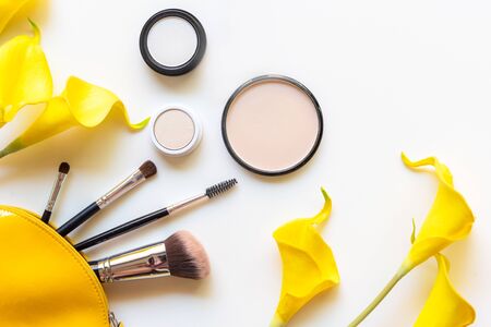 Makeup cosmetics tools and beauty cosmetics gift, products and facial cosmetics package lipstick with yellow flower on the white background, top view and copy space. Lifestyle Beauty Conceptの写真素材