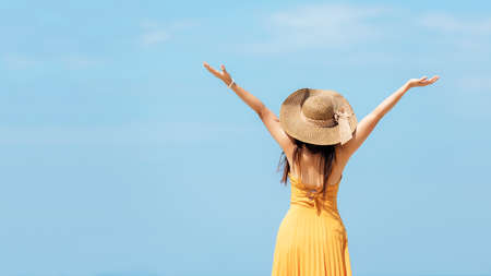 Summer Vacation. Lifestyle woman raise arm and hand on wave relax and happy on beach tropical outdoor in summer day. Young people luxury and destination in holiday. Tourism chill leisure of trips.の写真素材