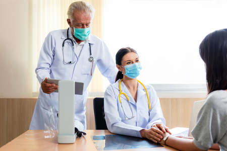 Medical doctor woman and team held the hand and consoled and comfort the patient in hospital and clinic room.の写真素材