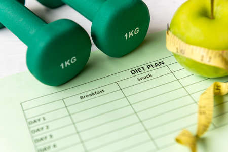 Diet Health Plan. Workout planing. Sport exercise equipment workout andÂ gym background with green...