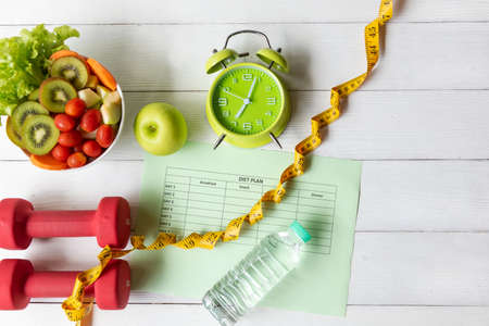 Nutrition start up workout and diet Health Plan.  Sport exercise equipment workout andÂ gym with nutrition fresh salad and green apple for fitness style. Healthy Lifestyle Concept, top viewの写真素材