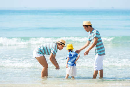 Happy family summer seaÂ  beach vacation. Asia youngÂ people lifestyle travel enjoy fun and relax in holiday. Travel and Family Conceptの写真素材