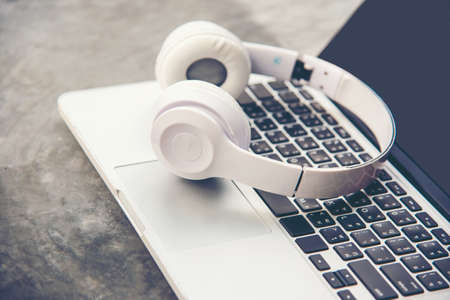 The laptop working and listen music on backboard in the  holiday. Music and Lifestyle Concept.