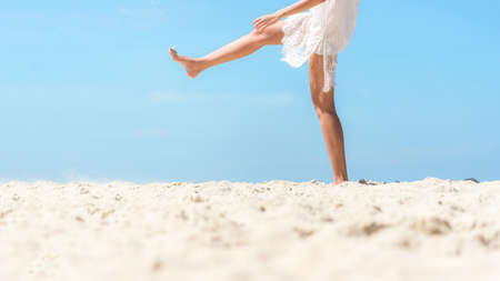 Close up leg. Summer Vacation. Lifestyle woman walking relax and happy on beach tropical outdoor in summer day. Young people luxury and travel destination in holiday. Tourism chill leisure of trips.の写真素材