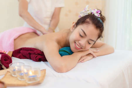 Spa beauty massage healthy wellness background. Spa Thai therapy treatment aromatherapy for body woman with flower nature candle for relax summer time. Lifestyle and Cosmetic Conceptの写真素材