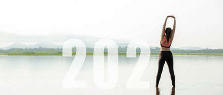 Happy new year start up 2021.  Yoga women lifestyle exercise and pose for healthy life. people balance body vital zen and meditation for workout sunrise morning nature background for success 2012. Health care Conceptの写真素材