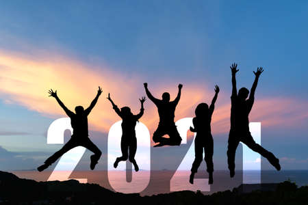 Silhouette happy business teamwork jumping congratulation and celebrate in Happy New year 2021 for change new life future concept. Freedom lifestyle group people team jump as part of Number 2021 success at the sunset beach outdoorの写真素材