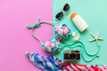 Summer items and accessories  traveler woman colorful bikini , camera go to travel plan holiday vacation in the beach. Tropical sea. Unusual top view, Travel and Summertime Concept.の写真素材