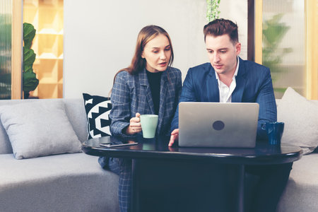 Business young people partner woman and businessman present and start up new project to success together outdoor modern nature office.  Woman and man drinking coffee and discuss business. Teamwork and Business Conceptの写真素材