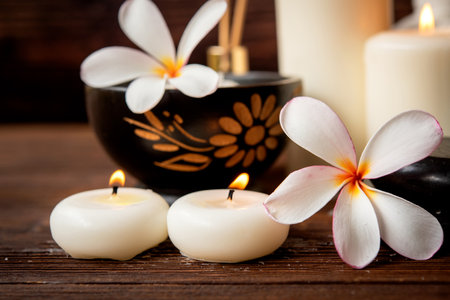 Thai spa massage. Spa treatment cosmetic beauty. Therapy aromatherapy for care body people with candles for relax wellness. Aroma and salt scrub setting ready healthy lifestyle.の写真素材