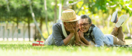 Asian senior elderly retire couple relaxation in the nature park happy and relax time.  People old and Elderly family the rest and chill  after retirement in vacations. Insurance and Lifestyle Conceptの写真素材