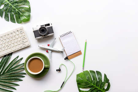 Top view of Traveler accessories and green cup coffee  with tourism backpack and visiting for planning trips travel destination and vacations,  leaf green and white background.  copy space for text.  Travel and Summer holiday conceptの写真素材