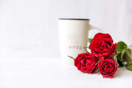 select focus. Valentine day.  Red Rose with cup coffee on white background.  Lover heart romantic in valentine day.  Holiday Conceptの写真素材