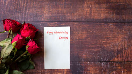 Valentine day.  Red Rose with card on old wood background.  Lover heart romantic in valentine day. ...