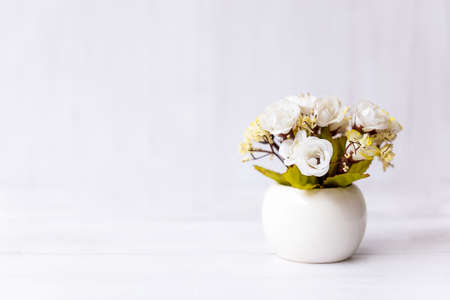 White rose flower on wood shelf white background.   copy space for text. Still life and Lifestyle Conceptの写真素材