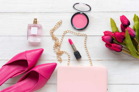 Fashion bag and shoe woman accessories white background. Trendy fashion luxury handbag, shoe, perfume and cosmetic design with pink lily flower. Lifestyle and Beauty Conceptの写真素材