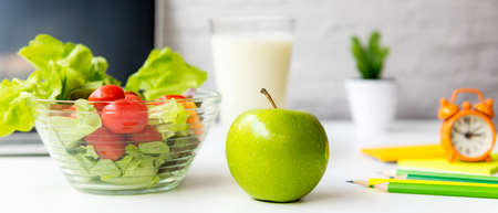 Healthy snack with working in office.  Green apple and fresh salad with water for diet Health Plan with laptop on white dress working.  Healthy Lifestyle Concept, copy space for bannerの写真素材