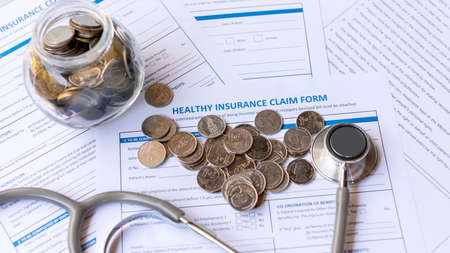 Saving money for insure Health insurance for healthy care form and protection people life with stethoscope.  Â Health insurance application form with banknote for life planning.  Healthy Conceptの写真素材