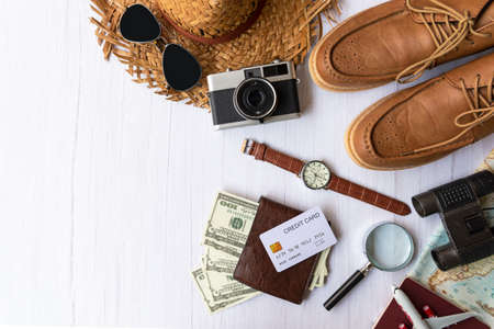 Top view of Traveler item accessories man and credit card with tourism backpack and visiting for planning trips travel destination and vacations on white world, copy space.  Travel and Summer holiday conceptの写真素材