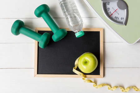 Diet Health Plan. Workout planing. Sport exercise equipment workout andÂ gym background with green apple fitness style. Healthy Lifestyle Conceptの写真素材