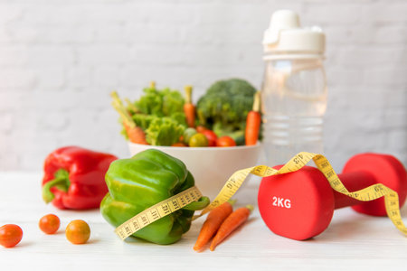 Diet Healthy food and lifestyle health concept. Sport exercise equipment workoutÂ andÂ gym background with nutrition detox salad for fitness style. Health care Conceptの写真素材