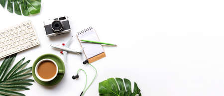 Traveler accessories and green cup coffee  with tourism backpack and visiting for planning trips travel destination and vacations,  leaf green and white background.  Top view and copy space for banner text.  Travel and Summer holiday conceptの写真素材