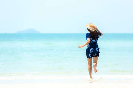 Summer vacations. Lifestyle woman relax and chill on beach background.  Asia happy young people running on the wave sea, summer trips walking enjoy  tropical beach. Lifestyle and Travel Concept.の写真素材