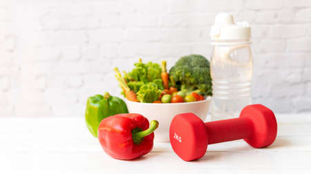 Close up dumbbell.  Diet Health food and lifestyle health concept. Sport exercise equipment workoutÂ andÂ gym background with fresh salad for fitness style. Healthy Lifestyle Conceptの写真素材