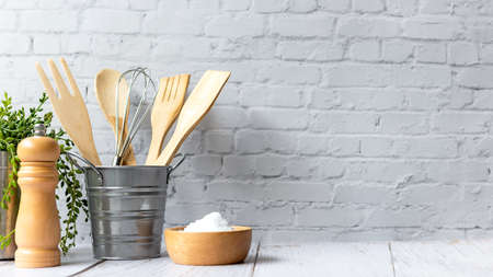 Kitchen tools and kitchenware utensil object on kitchen shelf wood white for healthy eat and health care life.  Wall white brick background, copy space for textの写真素材