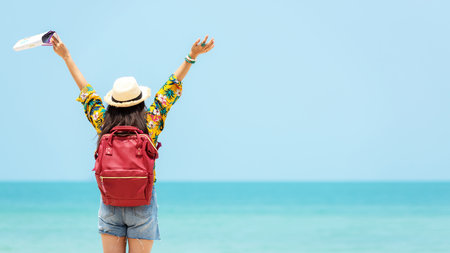 Happy traveler and tourism women travel summer on the beach.Â  Asia people holding map and raise arm planning travel trip and relax outdoor for destination and leisure.Â  Summer Vacation Travel Conceptの写真素材