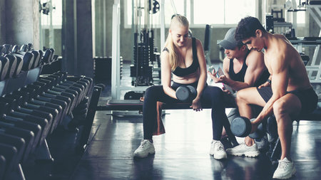 Trainer training exercise with man and woman at the gym for healthy care and body slim.  Fitness instructor exercising with his client people the fitness. Diet and Healthy sport Conceptの写真素材