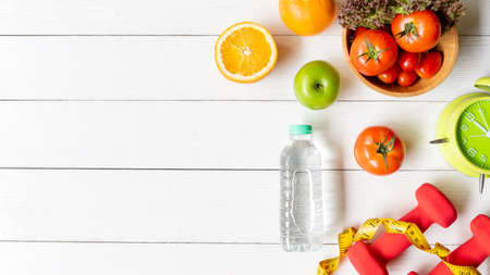 Diet Health eat and food for lifestyle health concept. Sport exercise equipment workout with fresh fruit and measuring tap for fitness style. Nutrition Healthy Lifestyle Concept, Top view and copy spaceの写真素材