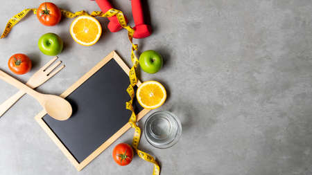 Diet Health eat and food for lifestyle health concept. Sport exercise workout and fresh fruit and measuring tape with backboard for fitness style. Nutrition Healthy Lifestyle Concept, Top view and copy spaceの写真素材