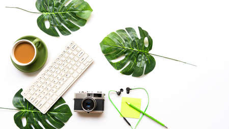 Traveler accessories and green cup coffee  with tourism backpack and visiting for planning trips travel destination and vacations,  leaf green and white background.  Top view and copy space for text.  Travel and Summer holiday conceptの写真素材