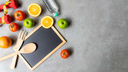 Diet Health eat and food for lifestyle health concept. Sport exercise workout and fresh fruit and measuring tape with backboard for fitness style. Nutrition Healthy Lifestyle Concept, Top view and copy spaceの写真素材