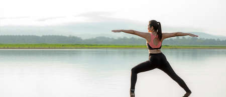 Yoga woman sitting zen and meditation for workout healthy life in sunrise morning. Young girl or people pose balance body vital  and exercise in nature background. Health care and Lifestyle Conceptの写真素材