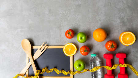 Diet Health eat and food for lifestyle health concept. Sport exercise workout and fresh fruit and measuring tape with backboard for fitness style. Nutrition Healthy Lifestyle Concept, Top view and copy spaceの写真素材