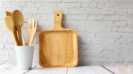 Kitchen tools and kitchenware utensil object on kitchen shelf wood white for healthy eat and health care life.  Wall white brick background, copy space for textの写真素材