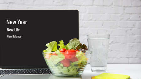 New Year for New Life and balance for Year 2022. Healthy snack with working in office.  Salad fresh water for diet Health Lifestyle.の写真素材