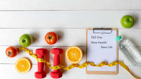New Year for New Changes Healthy 2022 timing 365 day.  Fresh vegetable fruits and healthy food for sport equipment for women diet slimming weight loss on white wood.  Healthy and Holiday Conceptの写真素材