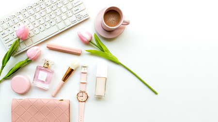 Stay beauty. Makeup beauty cosmetic fashion in office. Cosmetics woman working on laptop with bag product facial and coffee on white background. Lifestyle fashion Gift Concept, copy space for bannerの写真素材