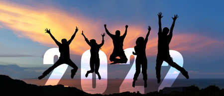 Silhouette happy business teamwork jumping congratulation and celebrate in Happy New year 2022 for change new life future concept. Freedom lifestyle group people team jump as part of Number 2022 success at the sunset beach outdoorの写真素材