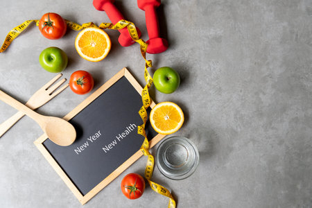 New Year for New Changes Healthy 2022.  Fresh vegetable fruits and healthy food for sport equipment for women diet slimming weight loss.  Healthy and Holiday Conceptの写真素材