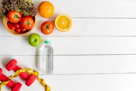Diet Healthy food and lifestyle health concept. Sport exercise equipment workoutÂ wood white background with fresh fruits and water for fitness style. Health care Conceptの写真素材