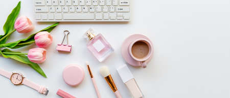Makeup beauty cosmetic fashion in office. Cosmetics woman working on laptop with bag product facial and coffee on white background. Lifestyle fashion Gift Concept, copy space for bannerの写真素材