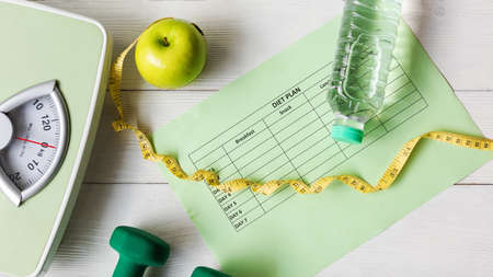 Diet Health Plan. Workout planing. Sport exercise equipment workout andÂ gym background with nutrition fresh salad for fitness style. Healthy Lifestyle Conceptの写真素材